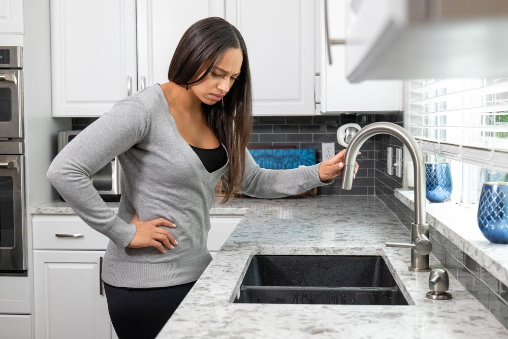 women standing near kitchen sink