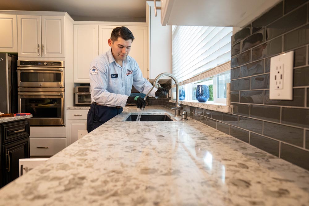 person checking kitchen tap